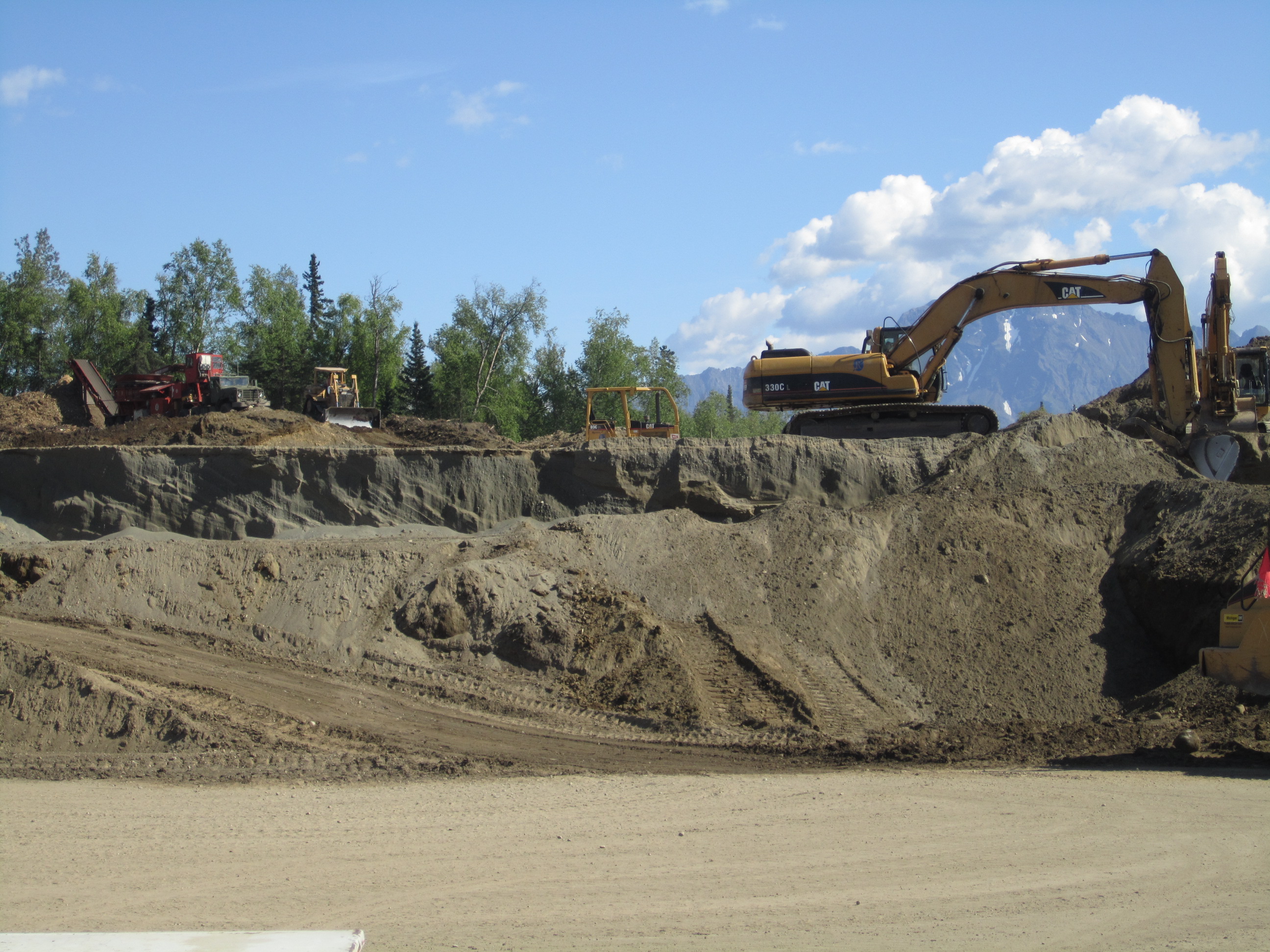 Excavator, dozer and loader, hailing dirt in wasilla alaska. 
